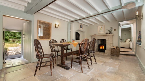 The dining room with woodburner at Boar Mill Cottage, Dorset